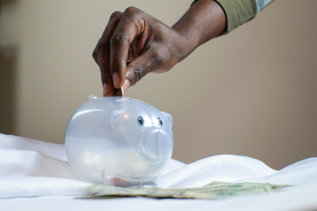 putting money in piggy bank